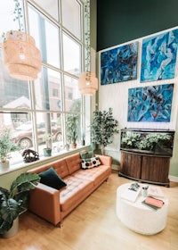 a living room with large windows and a couch