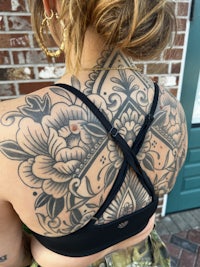 a woman with a tattoo on her back